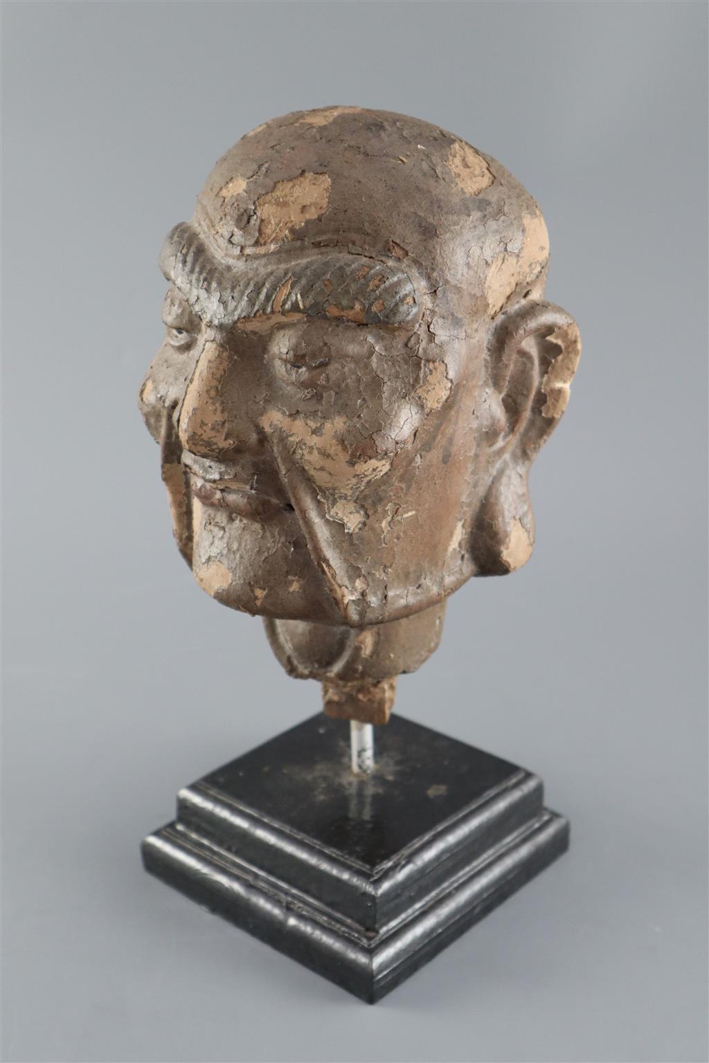 A Chinese clay and wood head of a luohan, possibly Song dynasty, 29cm high